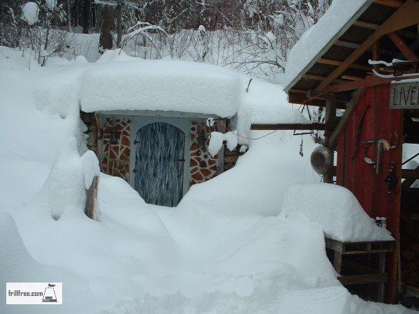 Glory Be, the earth sheltered root cellar under a blanket of snow
